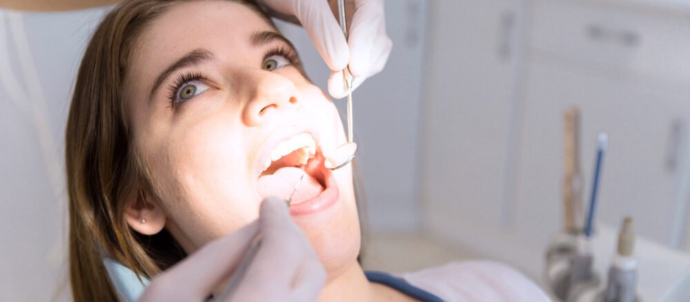 Dentist performing scaling and whitening treatment in Qusais at Lakeshore clinic