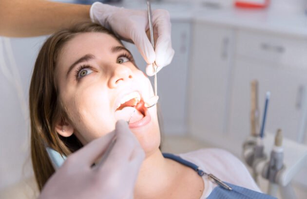 Dentist performing scaling and whitening treatment in Qusais at Lakeshore clinic