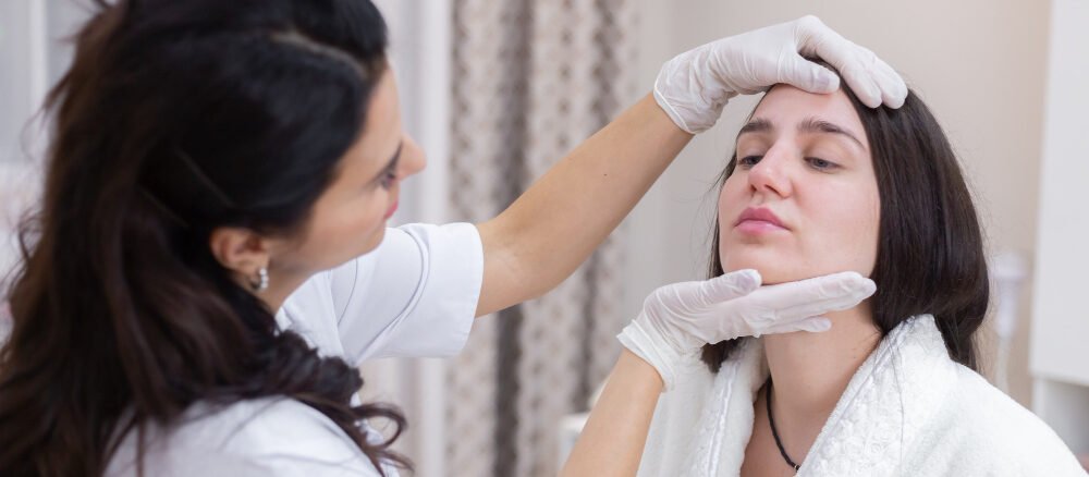 Woman receiving professional Acne Scar Treatment in Dubai for smoother and clearer skin at a modern aesthetic clinic.
